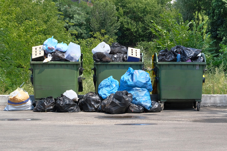 Dumpsters being full with garbage. Garbage is pile lots dump. Garbage waste lots junk dump.